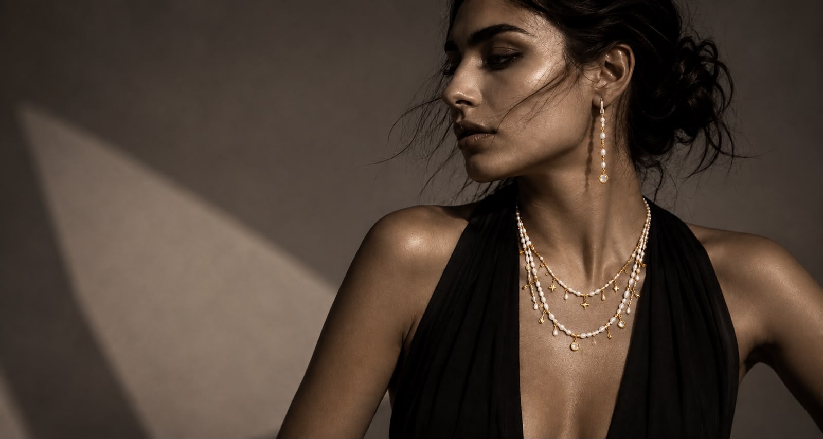 LUEL campaign portrait of a woman wearing a fine gold chain and sculptural earring